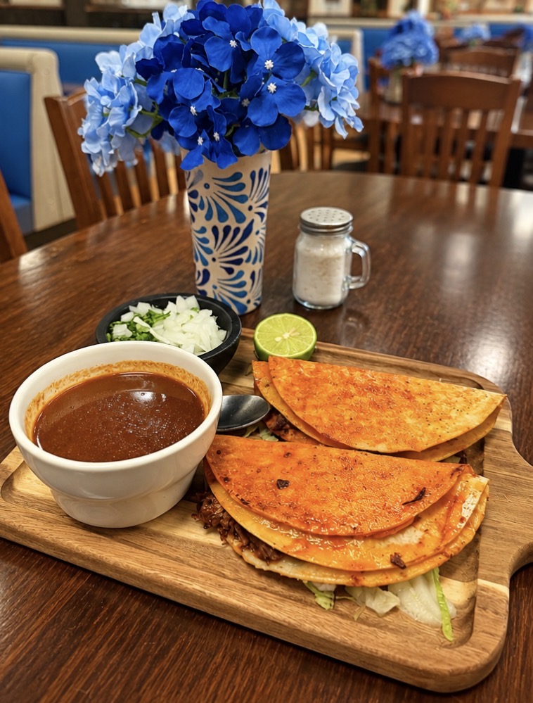 Quesabirria tacos served with consommé.